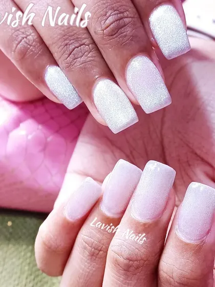 A clean and simple look with square-shaped nails in a shimmering, pearlescent white glitter polish.