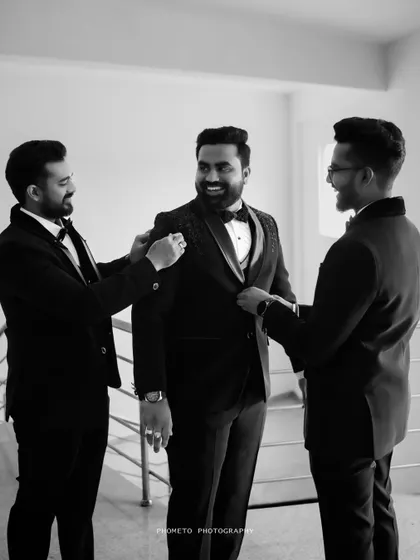 The groom getting ready with his groomsmen, a fun, candid moment of friendship and support before the ceremony.