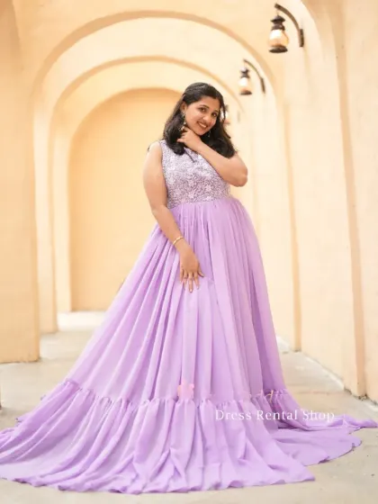 A lovely lavender gown with a sequined bodice and a flowing, ruffled hem. The combination of sparkle and soft fabric is perfect for a romantic look.
