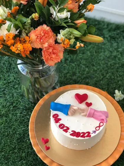 A sweet and simple cake celebrating a special date, with a "pinky promise" detail.