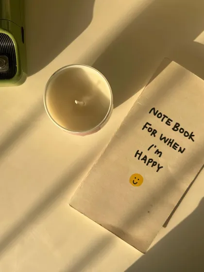 Candle means happiness. A simple, happy moment with our tin candle and a notebook.