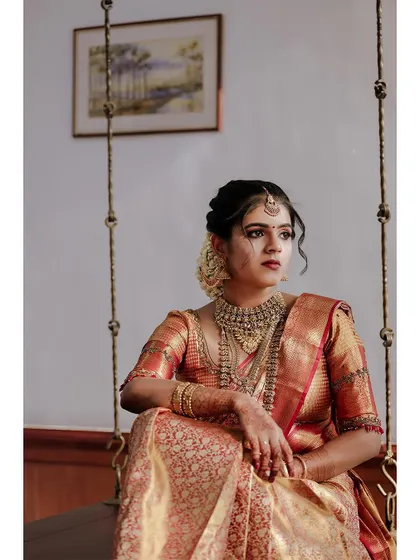 A pensive and regal portrait of the bride on a swing.