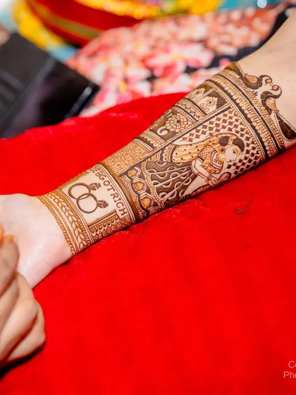 A close-up of the arm showing the wedding rings and the hashtag #DebGotRich, a personal touch for the bride's special day.