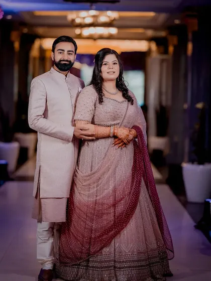 A formal full-length portrait of the couple at their Roka ceremony.