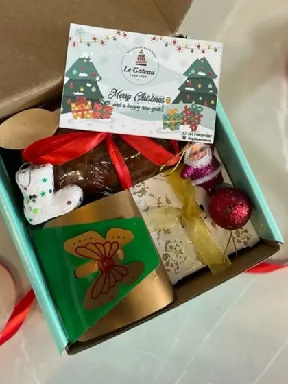 A look inside one of our custom Christmas hampers. This one includes our star-shaped plum cake, a festive candle, and other holiday goodies.
