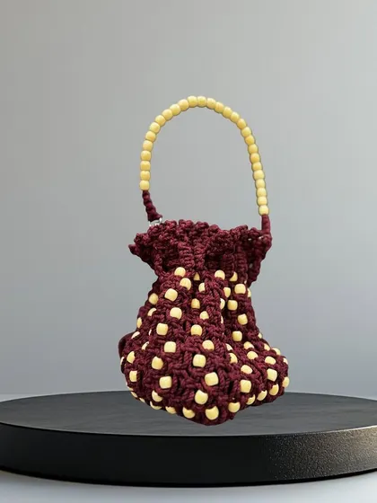 A closer look at the maroon and cream beaded potli bag. It's the perfect blend of traditional design and modern style.