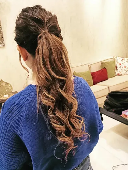 A textured ponytail with soft waves, perfect for a modern bride or bridesmaid. This style is chic, comfortable, and keeps the hair off the neck.