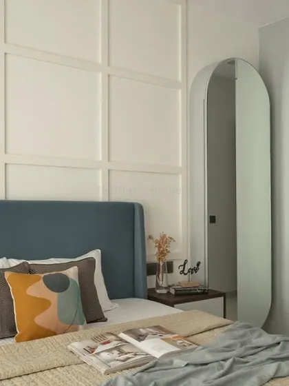 This perspective shows the full-length arched mirror and sliding wardrobe, demonstrating how I integrate thoughtful storage solutions to maintain a clutter-free and fluid environment.