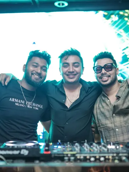 Posing with friends and fellow artists behind the decks. The music scene is a community, and I love sharing the console with other talented people.