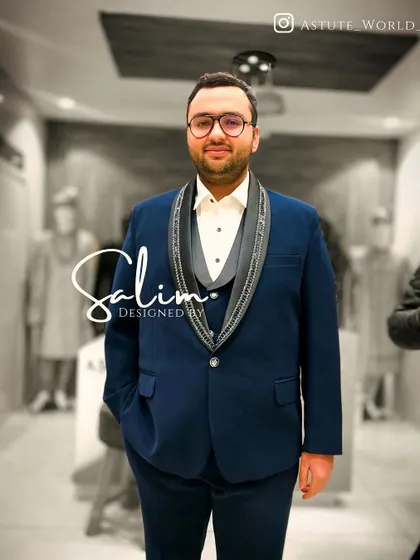 A client in a navy three-piece suit with embellished lapels. The fit is tailored to be sharp and modern, perfect for a wedding or formal party.