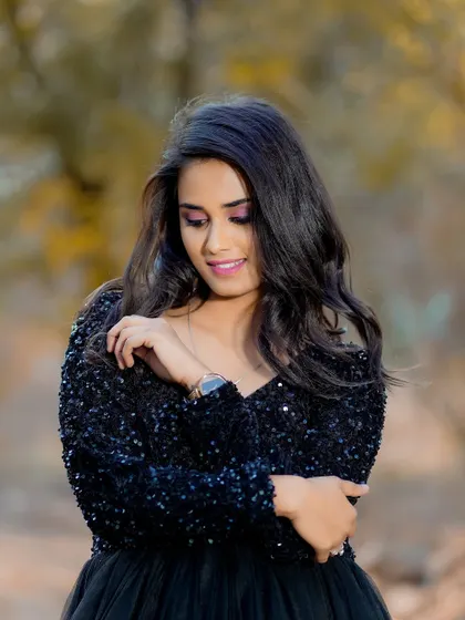 A close-up of the dramatic eye makeup for this outdoor fashion shoot. The vibrant pink and purple tones on the eyes add a beautiful contrast to the black gown.