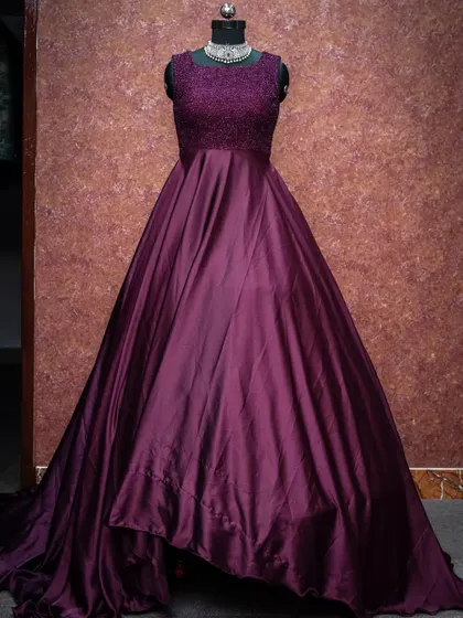 A deep wine-colored gown with a lace bodice for a touch of texture and elegance.
