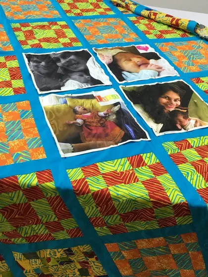 A unique memory quilt that incorporates printed photographs directly onto the fabric, surrounded by bright, modern patchwork.