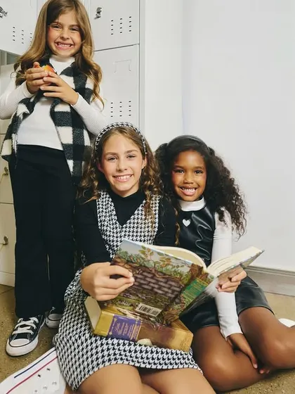 A "back to school" themed shot. The locker room setting and the interaction with books create a relatable story for the campaign.