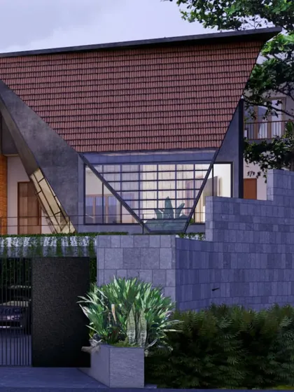 The dramatic sloped roof, made from a combination of traditional Mangalore tiles and modern glass, gives this house a unique and powerful silhouette. It is a contemporary reinterpretation of a classic regional material.