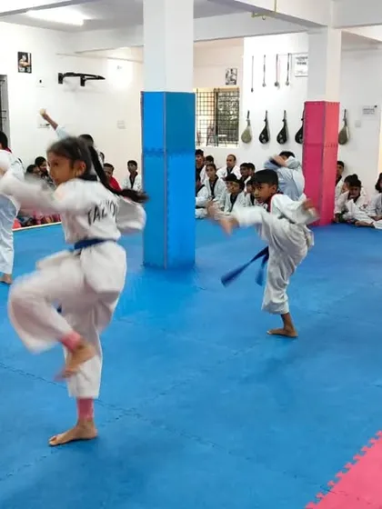 A student practices a front kick.