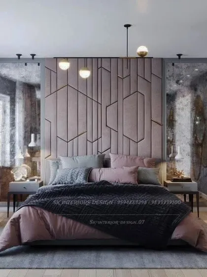 This moody and sophisticated bedroom features a custom geometric headboard in a dusty pink hue. The distressed mirrors on the sides add texture and an industrial-luxe feel.