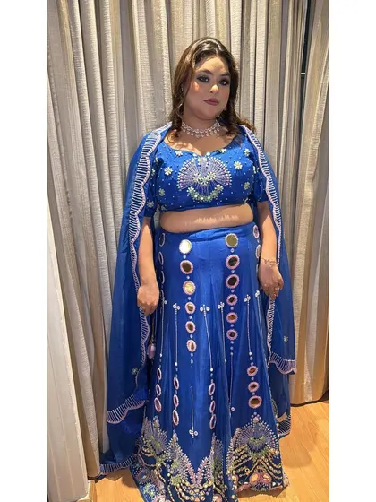 Another view of the unique royal blue lehenga, showcasing the cape-style dupatta. This adds a touch of drama and makes the outfit stand out.