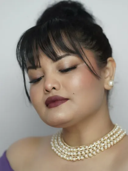 A serene, eyes-closed pose to showcase the soft, blended eyeshadow and the perfect winged liner. This look is a masterpiece of subtle details.