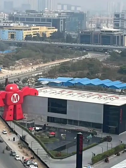 An aerial view of the T Works building during the Maker Faire. The design provides a large, flexible public plaza in front, which becomes an active hub for community gatherings and events, demonstrating how architecture can serve the city.