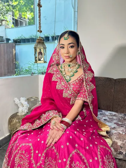 A seated portrait of a bride, showcasing her elegant floral updo.