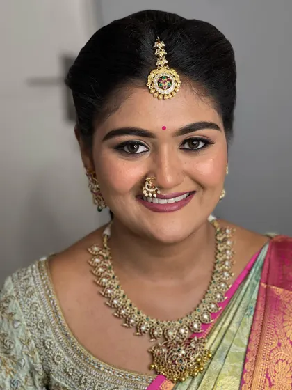 A happy, smiling close-up. This unfiltered portrait shows the real texture of the skin and how the makeup enhances her natural glow.