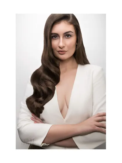 A portrait showcasing long, flowing, perfectly styled waves. This image speaks to glamour and hair health, key messages for a beauty brand.