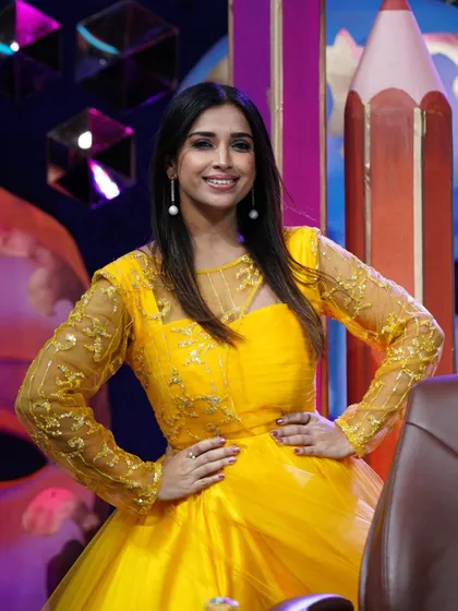 A full shot of actress Shwetha Changappa looking like sunshine in her custom yellow gown.