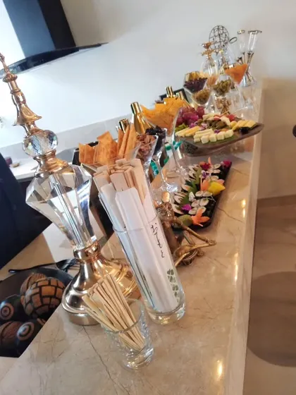 Another angle of the sophisticated appetizer station, showing the careful arrangement of snacks, chopsticks, and decorative elements to create an inviting display.
