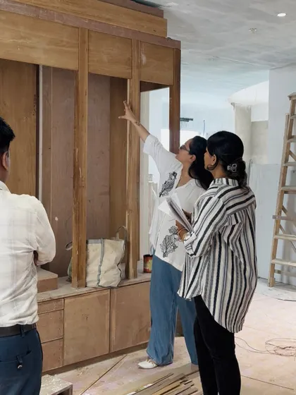 An architect on site, inspecting the woodwork and joinery for a custom storage unit. We conduct regular quality checks to ensure the craftsmanship meets our high standards and the design intent is perfectly realized.
