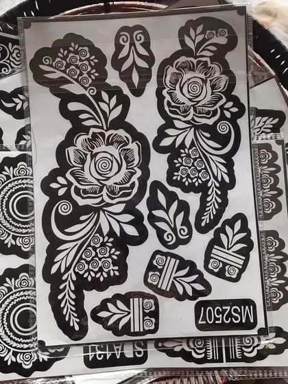 A close-up of the large rose stencil. You can see the fine details that will make your henna art look professionally done.