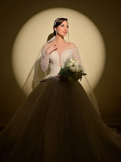 Another stunning shot under the spotlight, this time with the bride holding her bouquet.