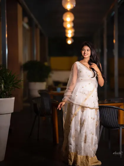 This shot captures the subject in motion, walking through the beautifully lit space. It adds a dynamic and candid feel to the event photography series.