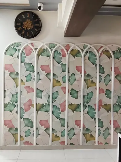 A wider view of the arched ginkgo leaf wallpaper, showing how it serves as a beautiful divider in an open-plan space.