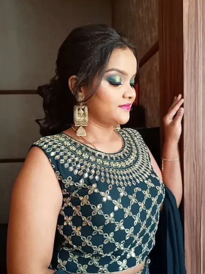 A close-up of the green halo-eye look, showing the blend of colors and the shimmer at the center of the lid. This is a popular technique for evening events.