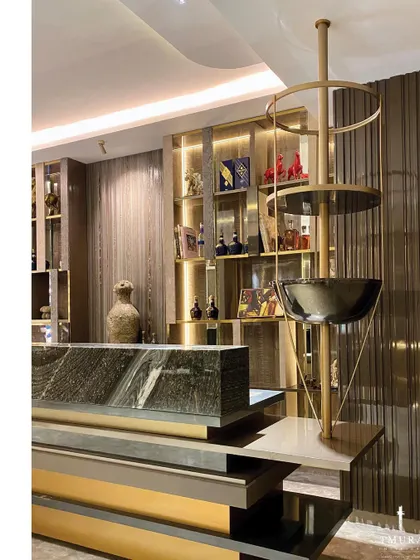 Every detail elevates the experience. This unique, floor-standing wine and glass holder is a sculptural piece in itself, crafted from metal to complement the modern bar area.
