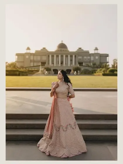A solitary bridal portrait against the grand facade of Raffles Udaipur. We take time to capture individual portraits that showcase elegance and grace.