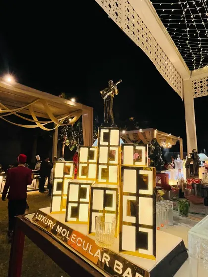 A geometric, illuminated structure used as a backdrop and display stand, adding a modern and artistic touch.