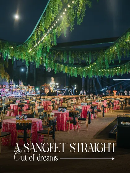A Sangeet straight out of a dream. The ceiling is draped with lush greenery and fairy lights, creating an enchanted forest feel for this magical night of dance and music.
