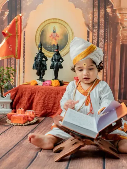 A focused shot of the baby looking intently into the book, creating a sweet and story-like image.