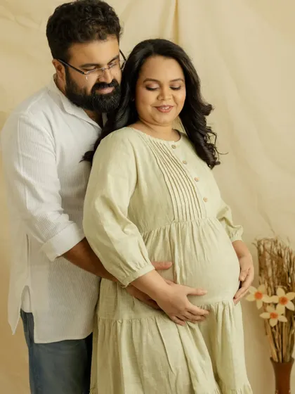 A lovely couple's portrait in soft, neutral tones. The gentle way he holds you from behind shows his love and support on this journey.