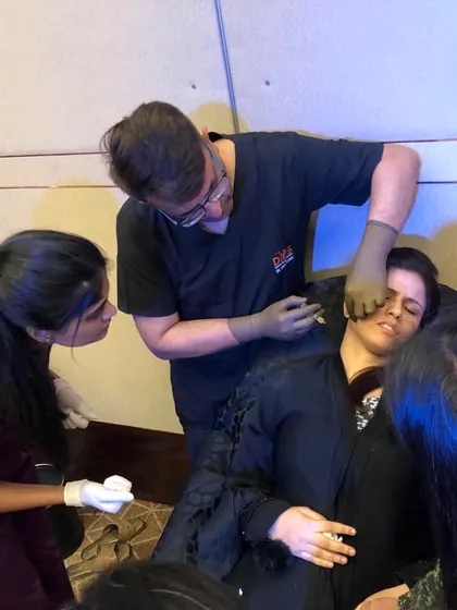 Teaching is most effective when it's interactive. Here, I'm guiding a group of dermatologists through the intricacies of filler application, ensuring every question is answered and every technique is understood.