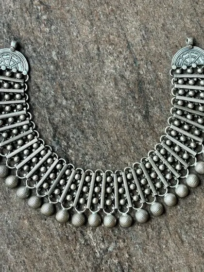 Another view of the multi-segment oxidised silver necklace, showing its flexibility and intricate construction.
