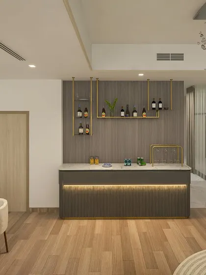 The sleek credenza-cum-bar in the Dubai home features a fluted design and a marble top, seamlessly blending function with high-end aesthetics.