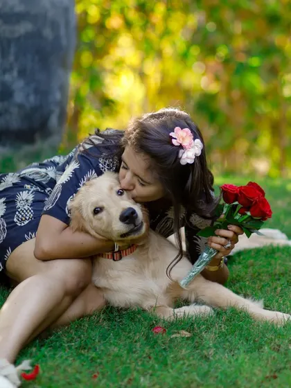 A gentle kiss for a beloved furry friend. This image captures the deep affection between Aishwarya and her golden retriever.