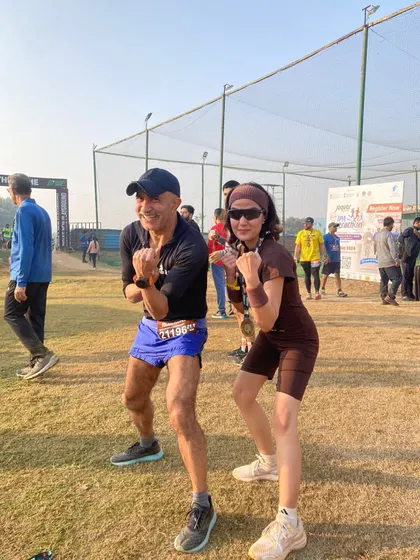 The coach with a tribe member, both striking the signature GRR pose after the Aravali Trail Run.