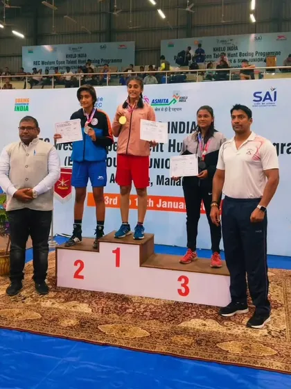 Our champion Nishi Patel on the winner's podium, taking the number one spot. We train our athletes to aim for the top.
