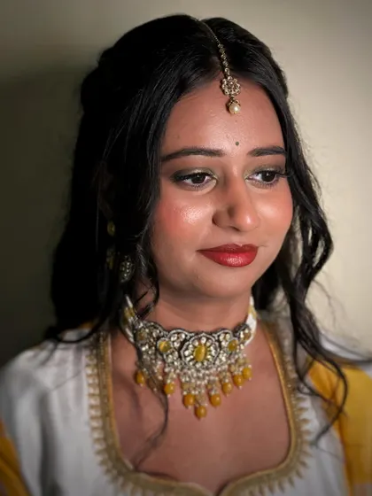 A vibrant Haldi makeup look. I used a pop of green eyeshadow to add a fun twist, complementing the yellow and white theme of her outfit.