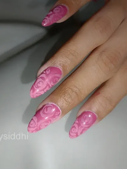A close-up of the 3D rose-embossed nails, showing the intricate, repeating floral pattern.