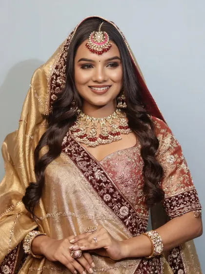 A happy bride is the most beautiful bride. This shot captures the complete 'Riwayat' look, with the dupatta framing her glowing face and effortless open waves.